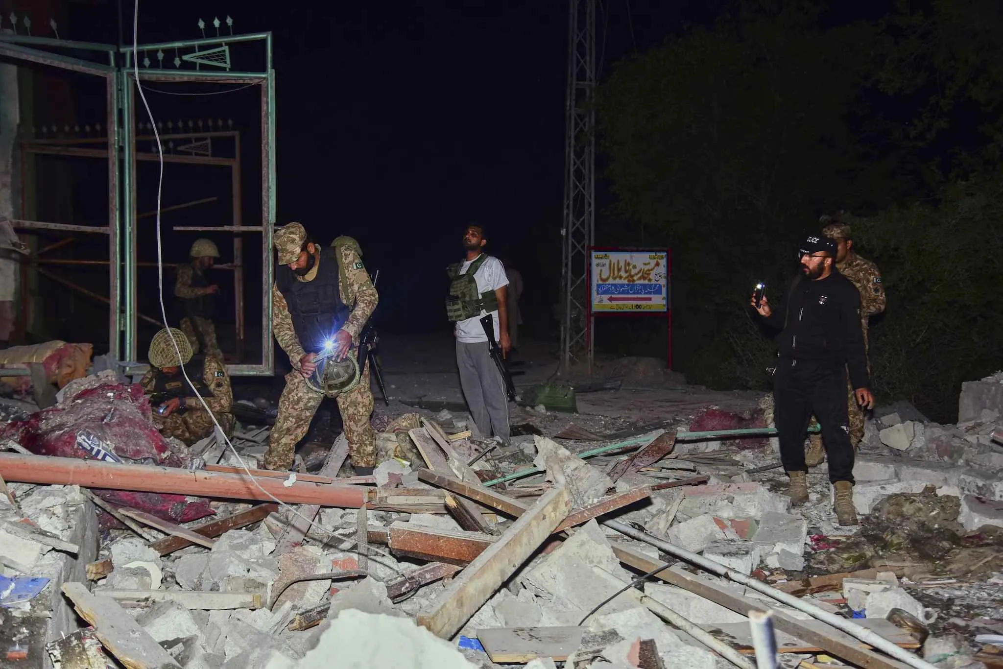Pakistani soldiers inspecting the sites destroyed in the Indian Army's strike.